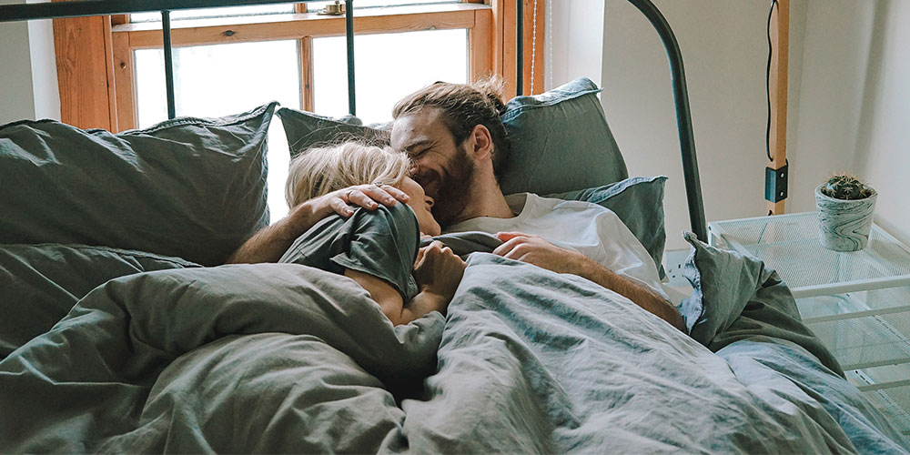 photo of a happy couple in the bed