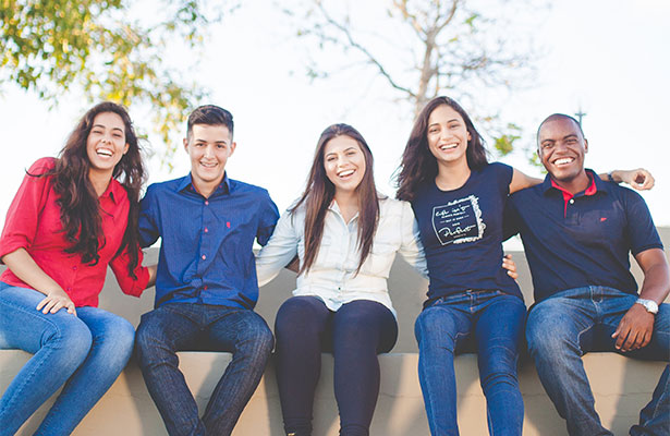 photo of young group sitting in a bench