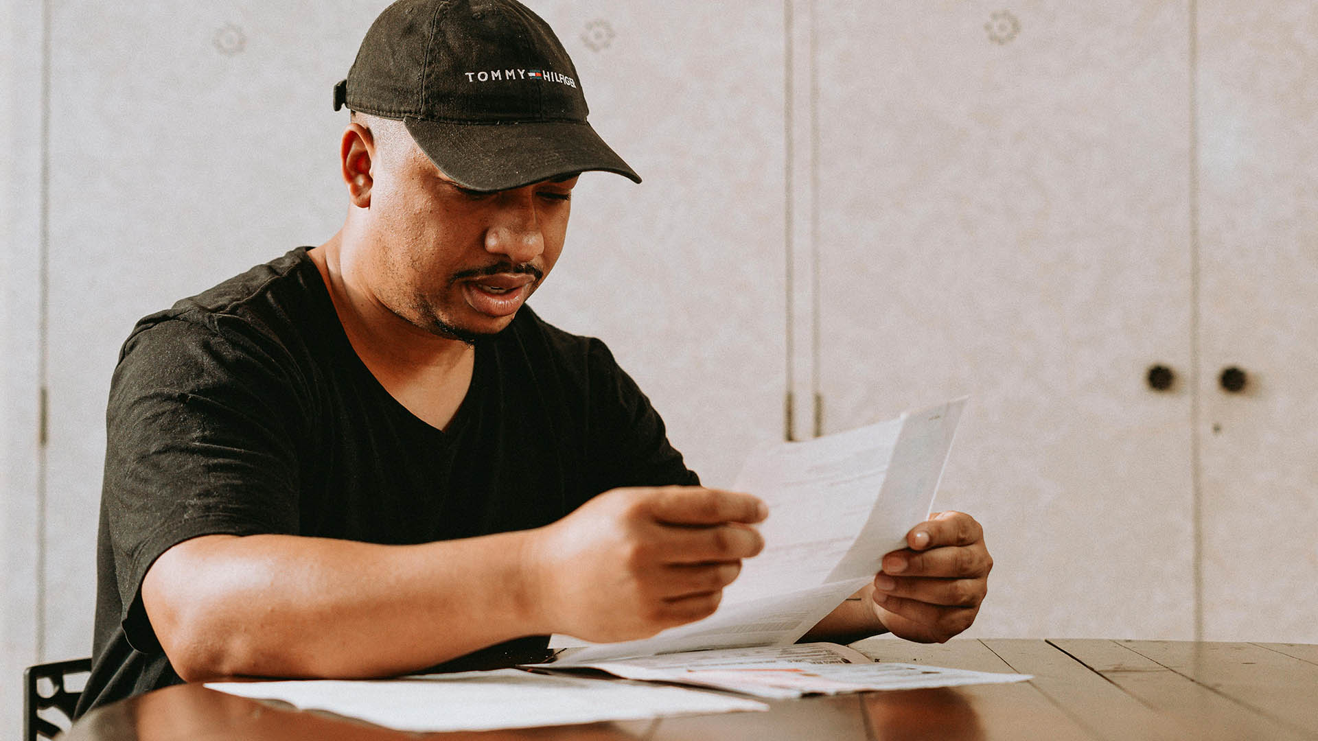 main in the table holding a paper