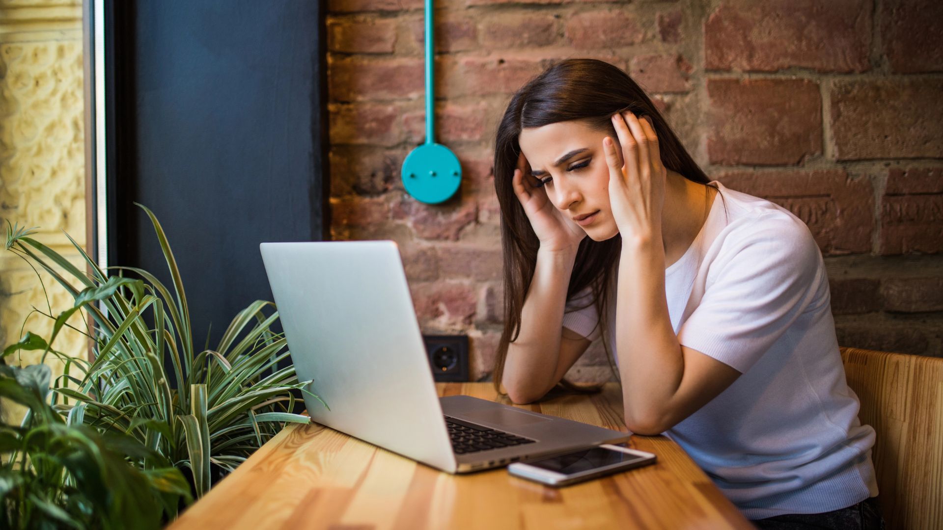 sad woman holding computer