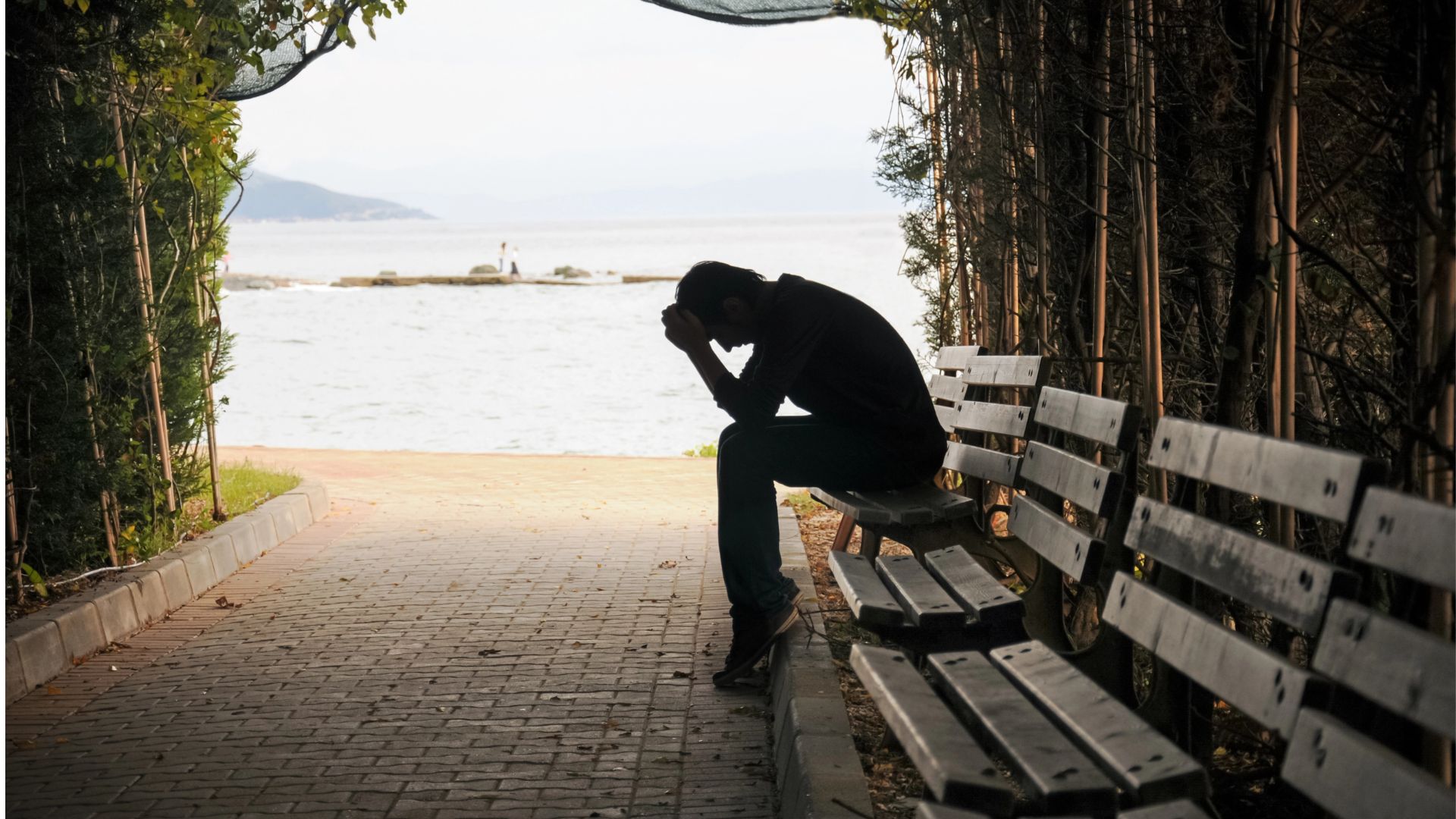 young man sitting looking upset