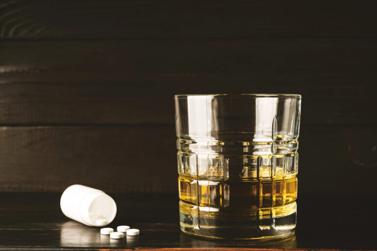 alcohol drink glass and white pills