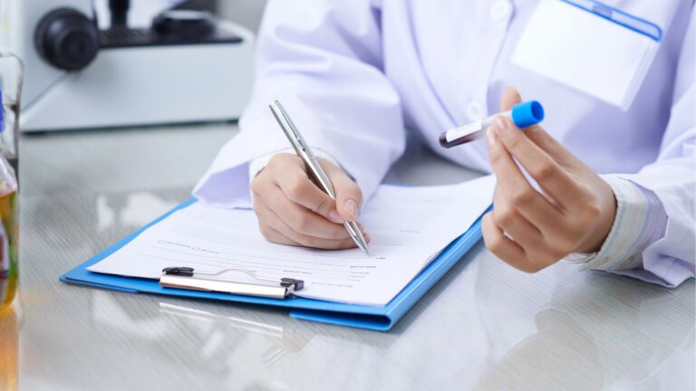 Medical worker writing results of blood test