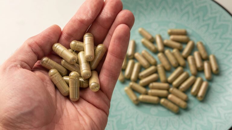 hand holds some kratom pills