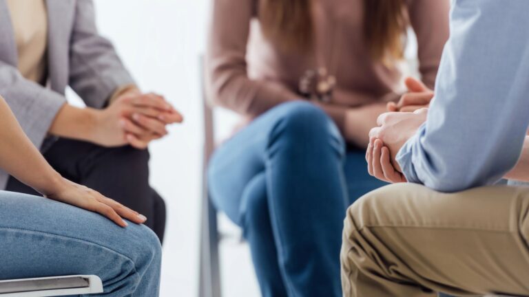 people sitting during group therapy session