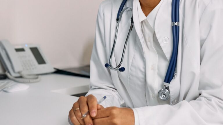 A female doctor seated at a desk