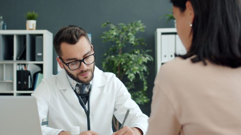 Doctor in white coat consulting patient