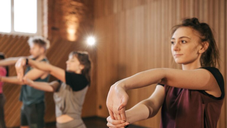 Individuals stretching during a fitness class